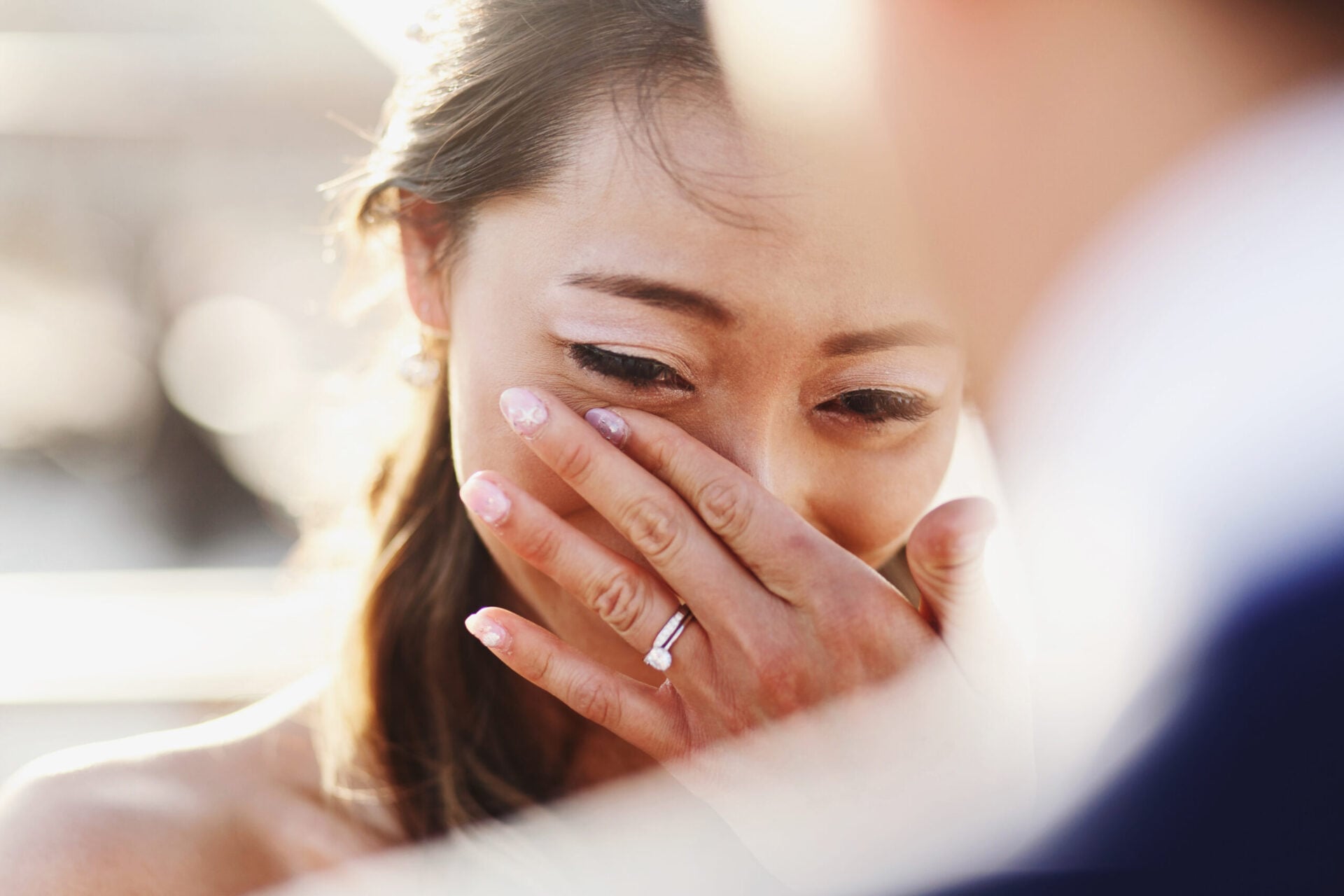 Groom looks over his shoulder at the happy, tearful bride