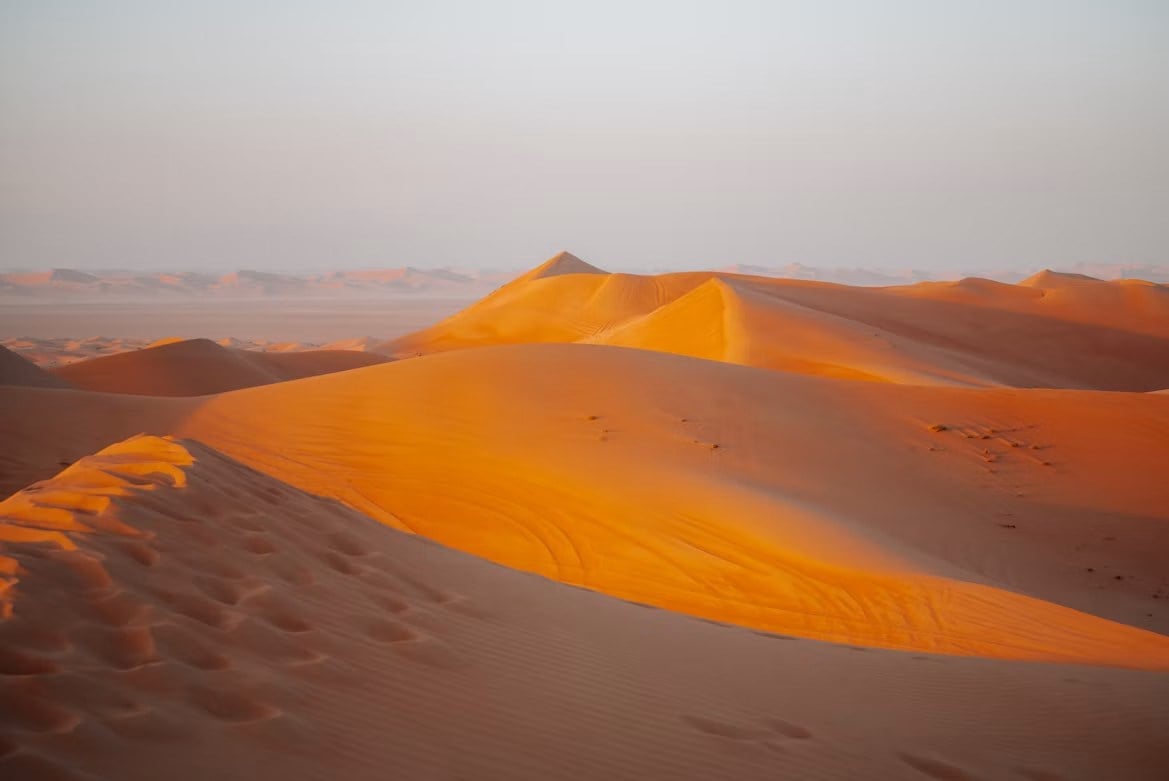 Goldene Sanddünen in der Wüste bei Dubai im warmen Abendlicht